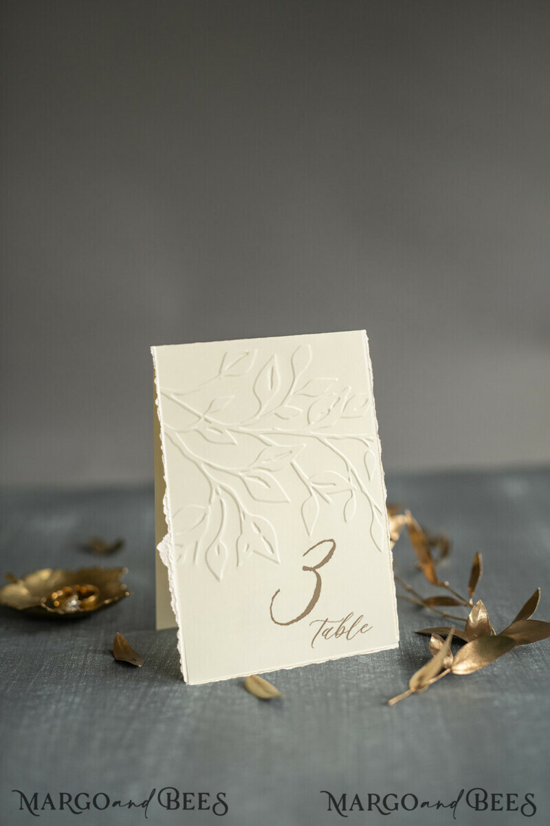 TABLE DECOR SIGNS glitter Elegant Wedding Table Number Card with Embossed Floral Design – Ivory Textured Paper, Folded Tent Style, Classic Font, Luxury Reception Decor